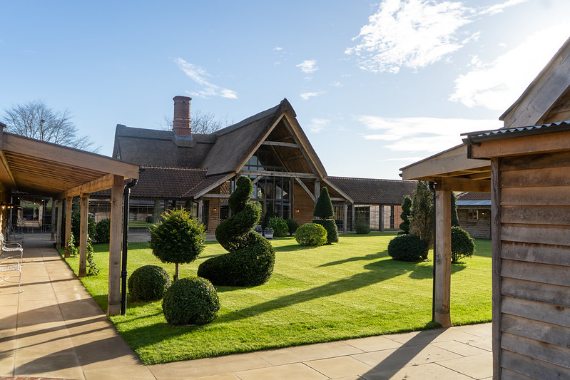 Chapel Barn at Wilderness Reserve with thatched roof and topiary gardens